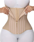 Close-up of beige waist trainer corset with front zipper fastening and structured boning, shaping compression garment for women UK