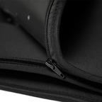 Close-up of the black fabric, stitching and zipper mechanism on the NACRE FORM™ Full Body Red Light Therapy Blanket, highlighting the convertible modular construction that allows the wraparound LED therapy blanket to separate into two individual red light therapy mats.