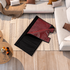 NACRE FORM™ Full Body Red Light Therapy Blanket displayed partially unfolded on a textured cream rug in a luxurious modern living room. The flexible black wraparound LED therapy blanket features a foldable design with glowing red LED lights and soft fabric panels. Combining 660nm red light and 850nm near-infrared technology, this full-body red light therapy blanket features 2,520 LEDs and can separate into two individual therapy mats, offering a versatile at-home red light therapy experience for personal we